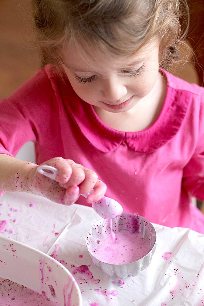 spooning bubbles from foaming heart dough spooning bubbles from foaming heart dough